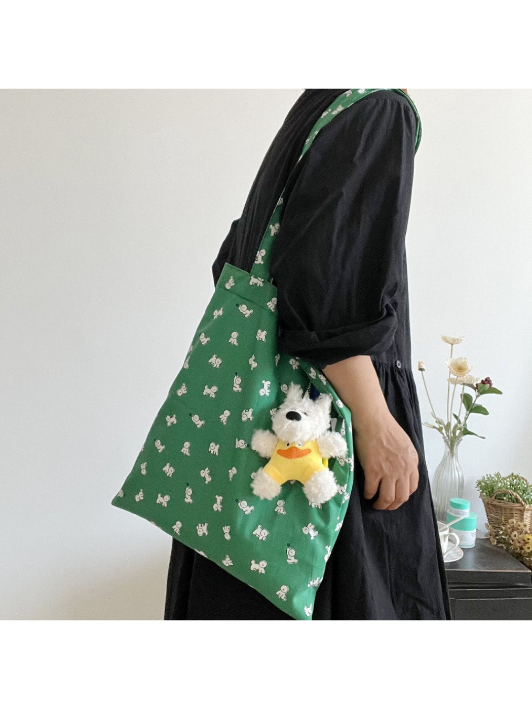 Green slouch tote bag with puppy graphic on front, front view