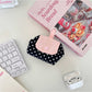 Cosbai mini polka dot pouch bag placed on a white surface with shadow