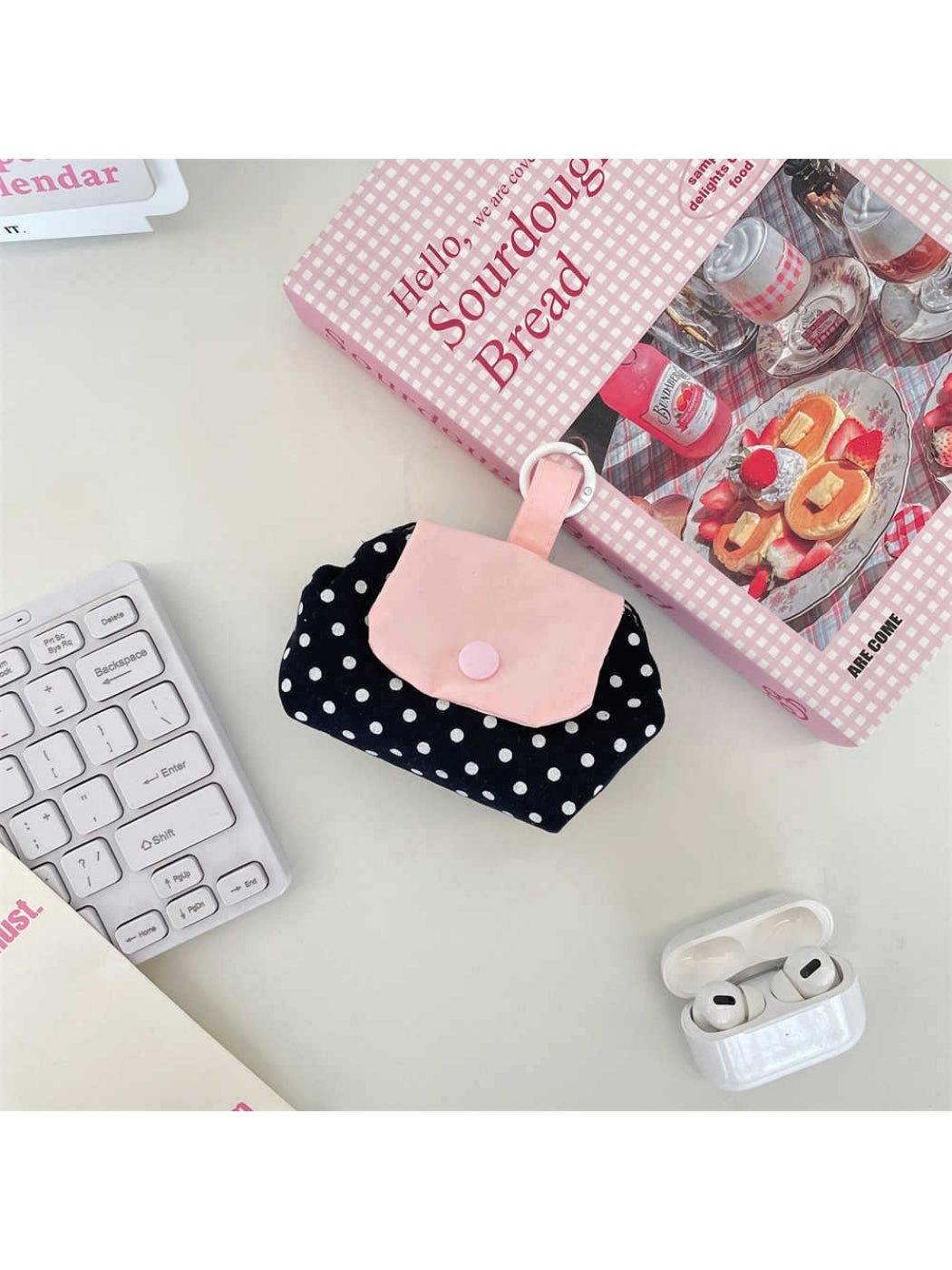 Cosbai mini polka dot pouch bag placed on a white surface with shadow