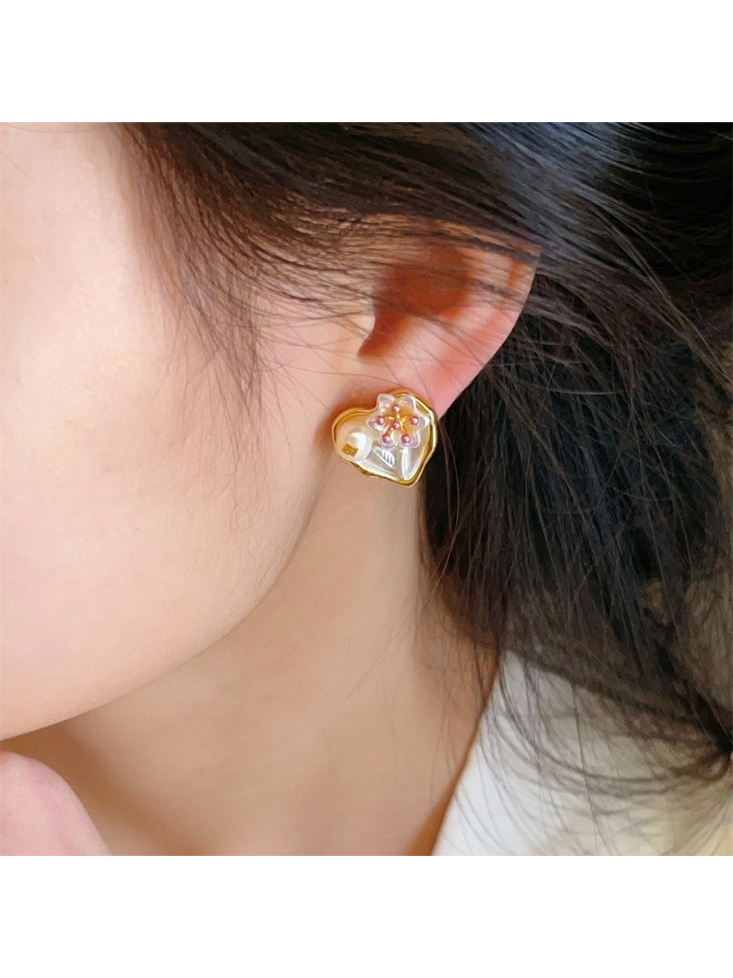 Pair of Earwish Romantic Floral Heart Earrings shown against a soft pink background