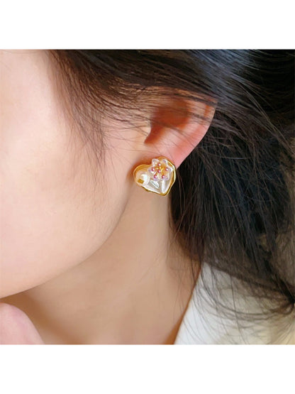 Pair of Earwish Romantic Floral Heart Earrings shown against a soft pink background