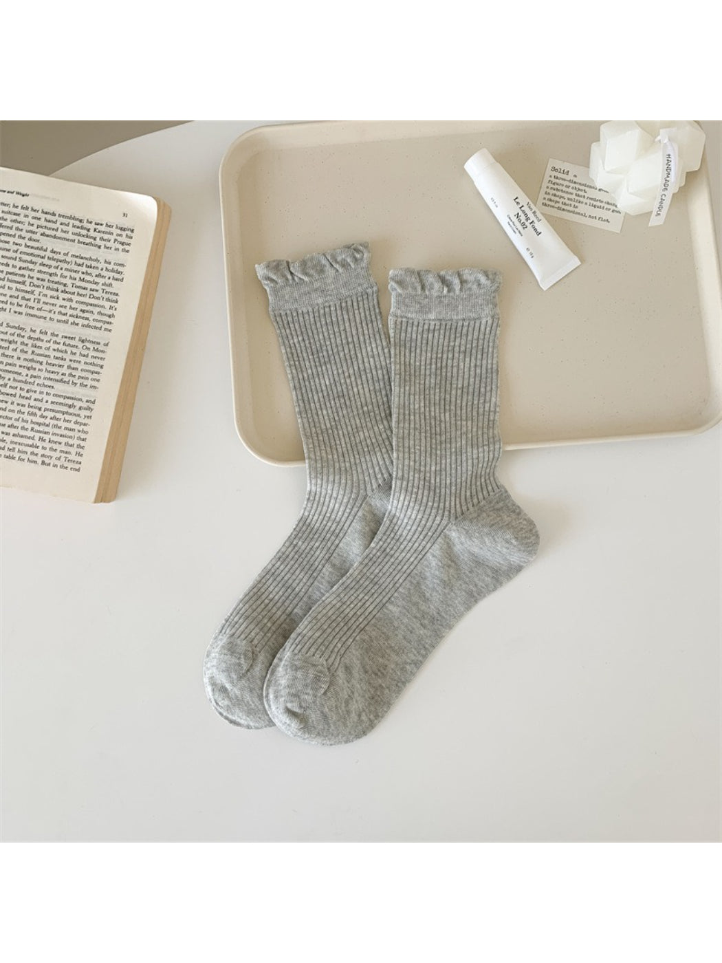 Flat lay of Rufia Everyday Ruffle Cuff Crew Socks with packaging and branding visible