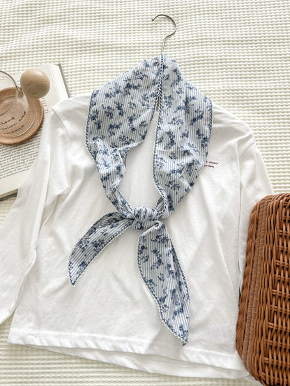 Floral stripe lace skinny scarf folded neatly showing texture and pattern details