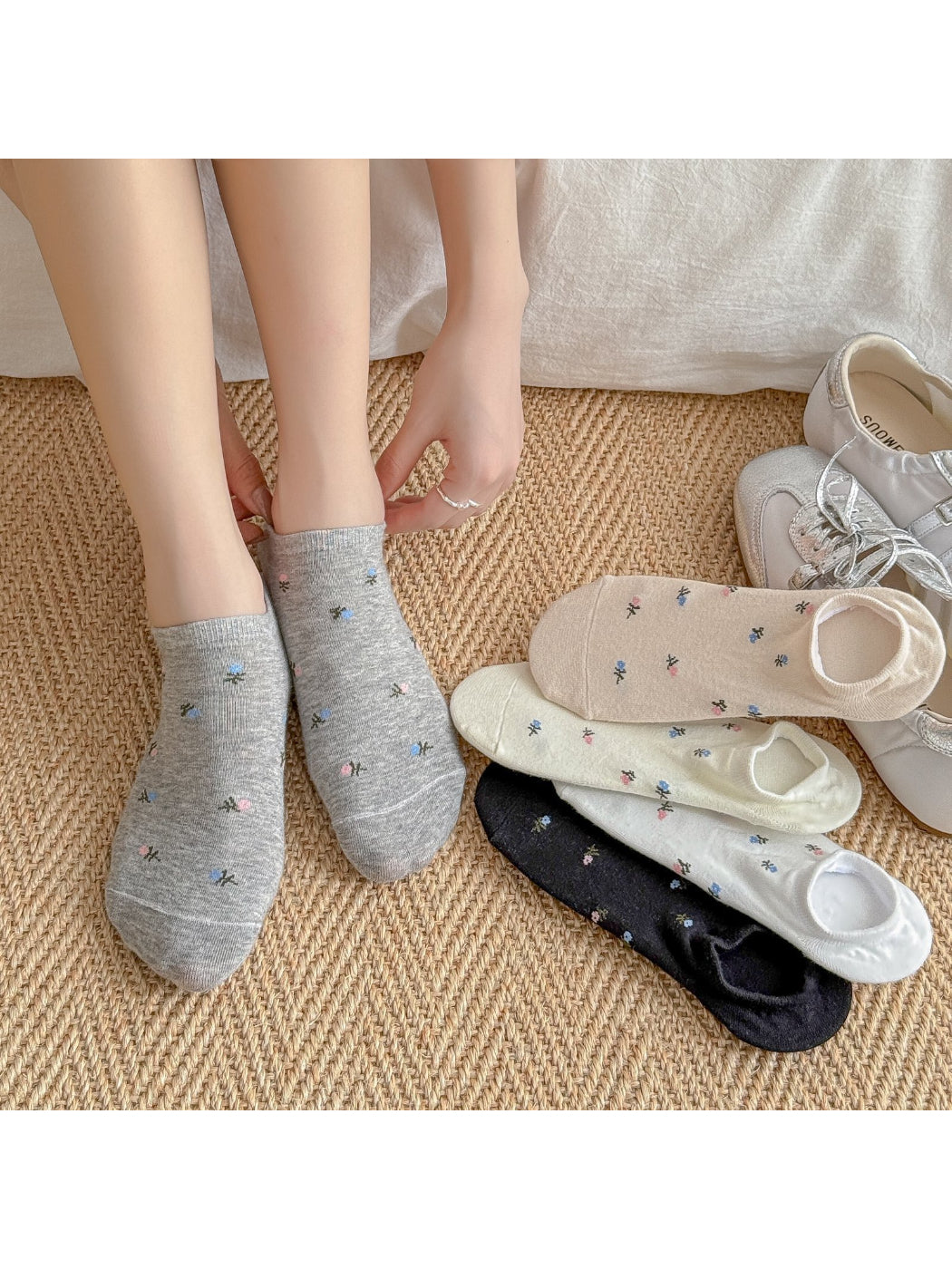 Pair of Rufia Everyday Bloom no show socks with floral pattern on white background