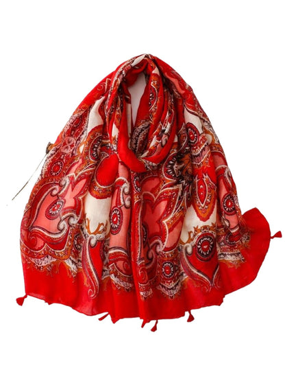Scarvii scarf draped over a chair displaying full paisley pattern and tassel fringe