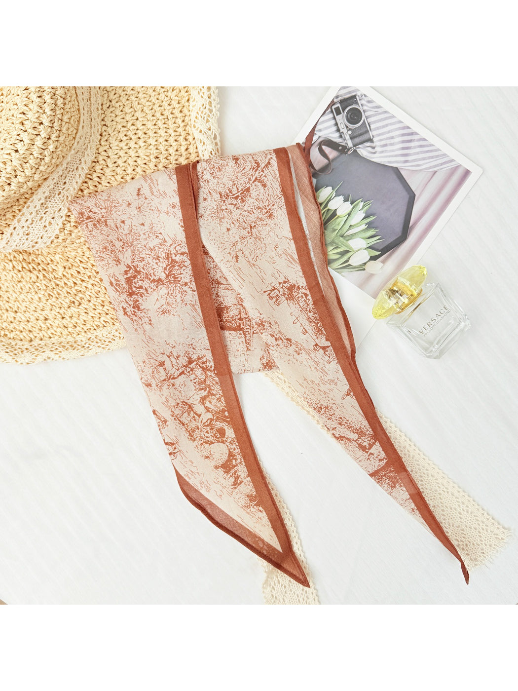 Scarvii scarf laid flat highlighting vibrant abstract print and triangle shape