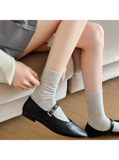 Single Rufia knit white crew sock standing upright highlighting knit pattern