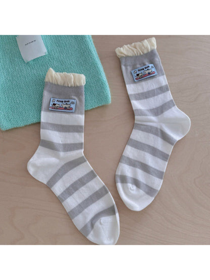 Close-up of embroidered patch on Rufia pastel pink ribbed socks