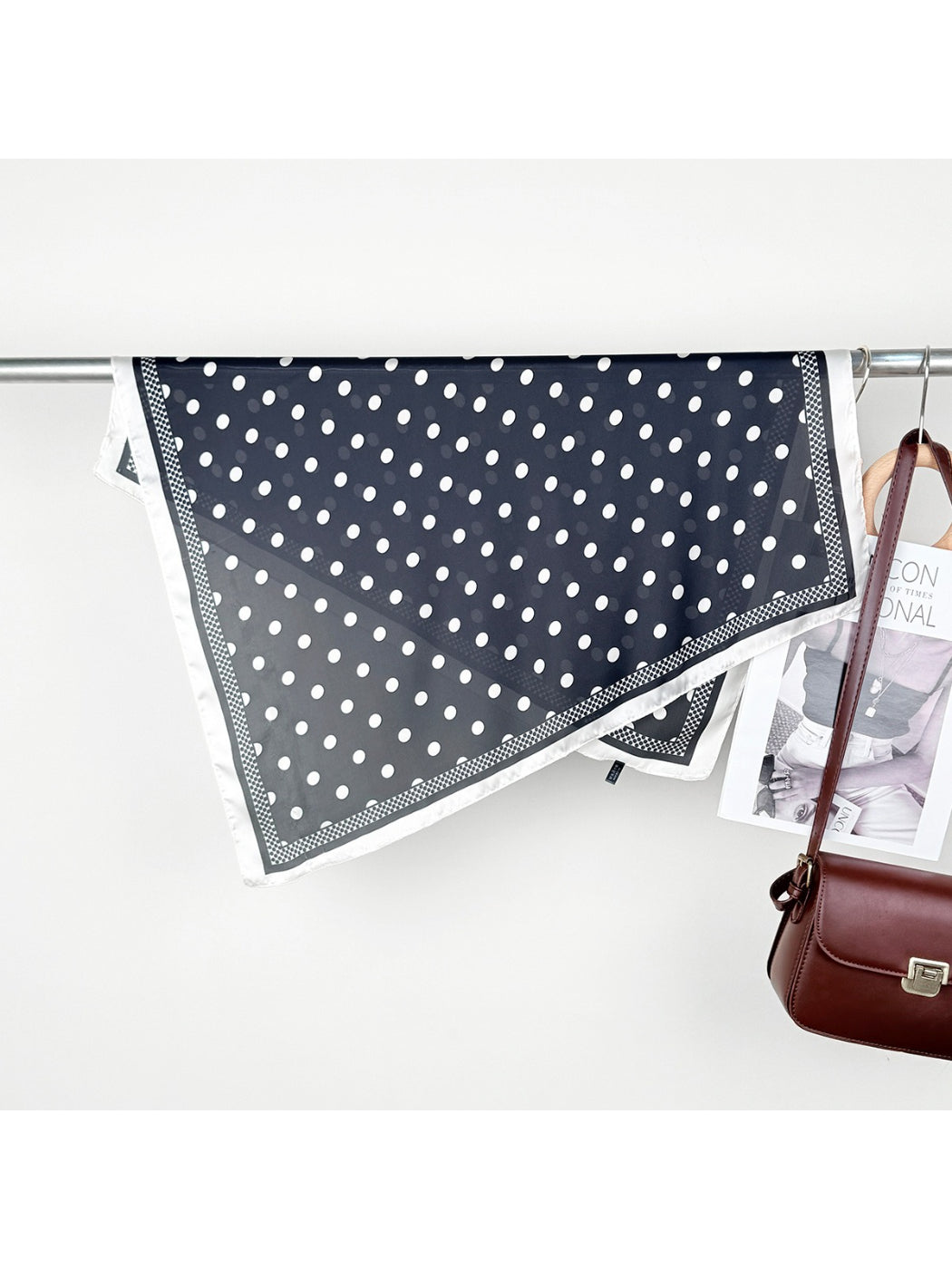 Scarvii scarf draped over a chair highlighting the polka dot design