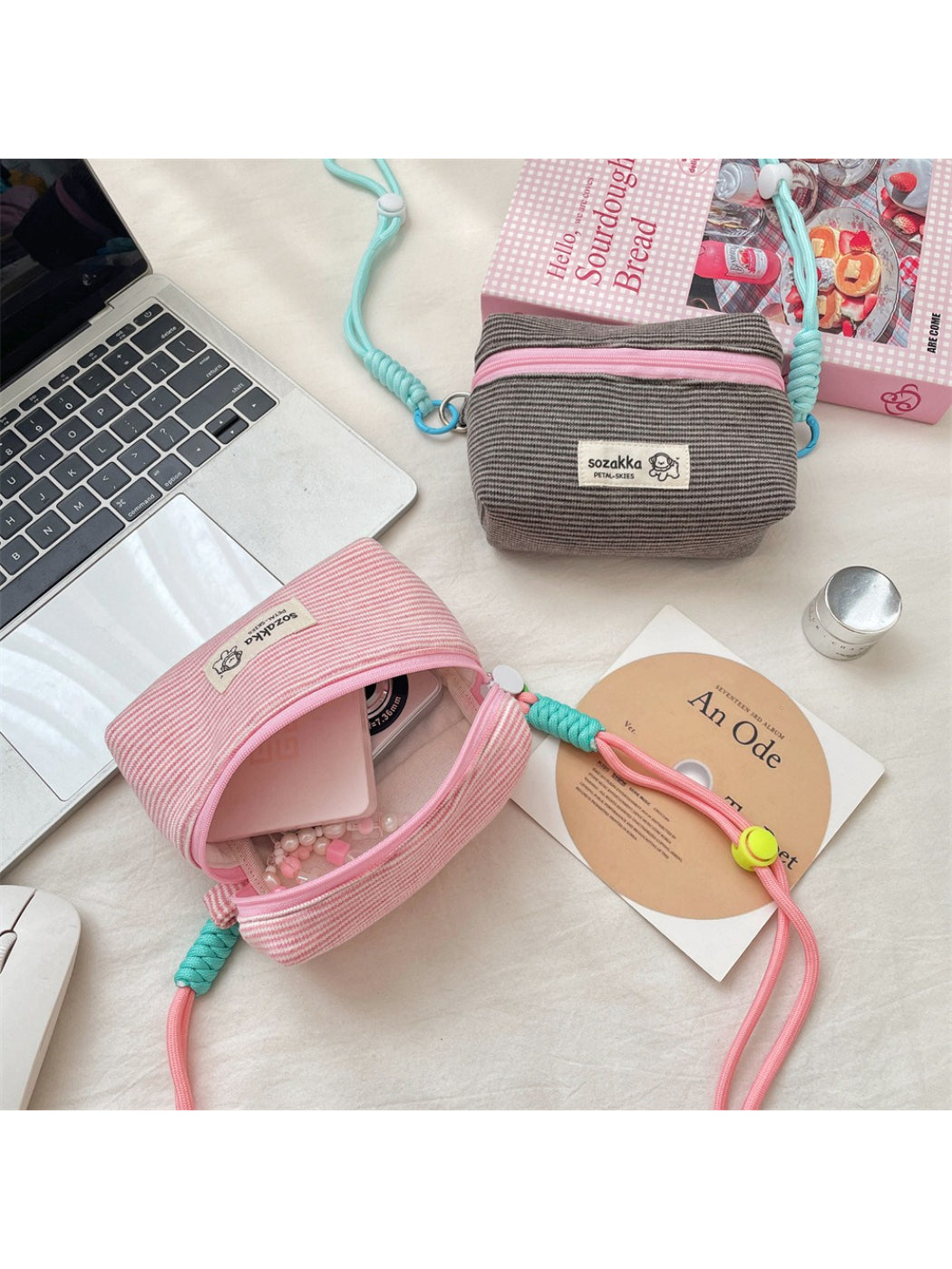 Close-up of the Cosbai striped mini crossbody pouch showing the zipper and fabric texture