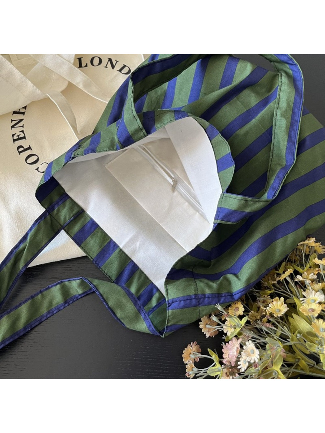 Interior view of Cosbai green stripe shoulder tote bag with open top