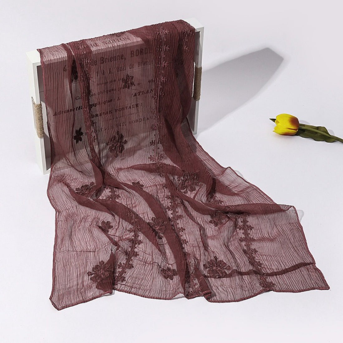 Scarvii scarf in natural light emphasizing soft fabric and blossom stitch design