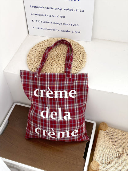 Cosbai plaid tote bag held by model wearing casual outfit