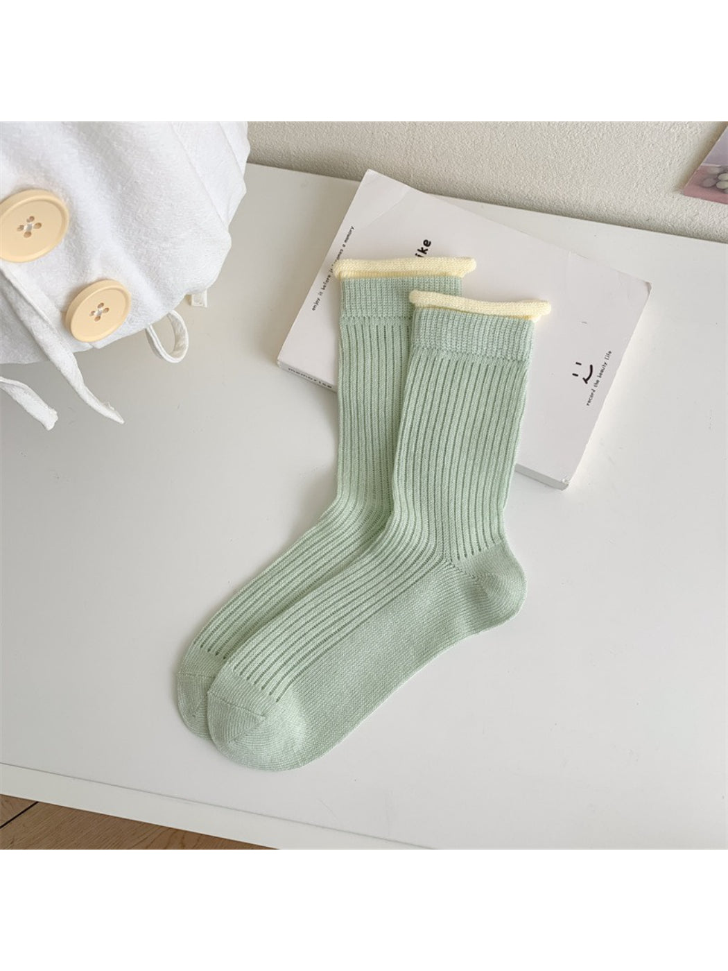 Side view of Rufia ribbed crew socks highlighting pastel orange contrast trim