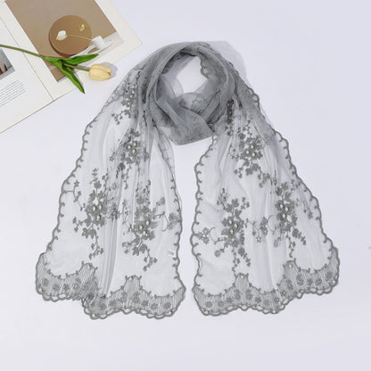 Side view of model wearing sheer botanical mesh scarf with casual outfit