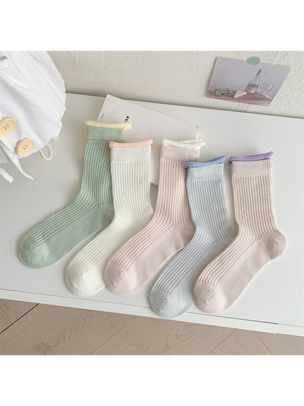Model wearing Rufia ribbed crew socks with pastel green contrast trim paired with casual shoes