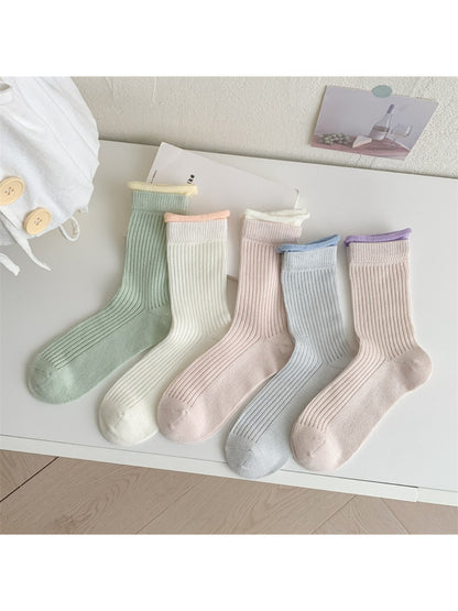 Model wearing Rufia ribbed crew socks with pastel green contrast trim paired with casual shoes