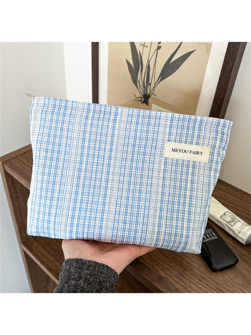 Side view of Cosbai blue check cosmetic bag highlighting its compact size