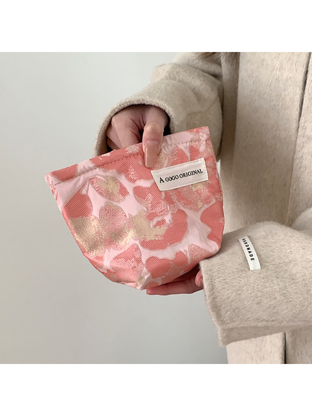 Cosbai blush floral cosmetic bag with pink and white flower pattern on a light background