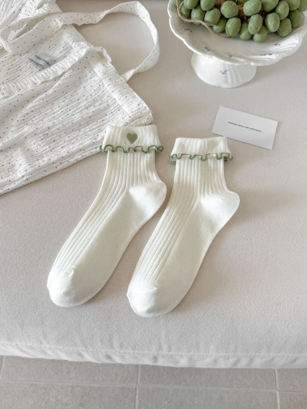 Rufia Sweet Heart Edge Ribbed Socks styled with a skirt, highlighting scalloped heart edge
