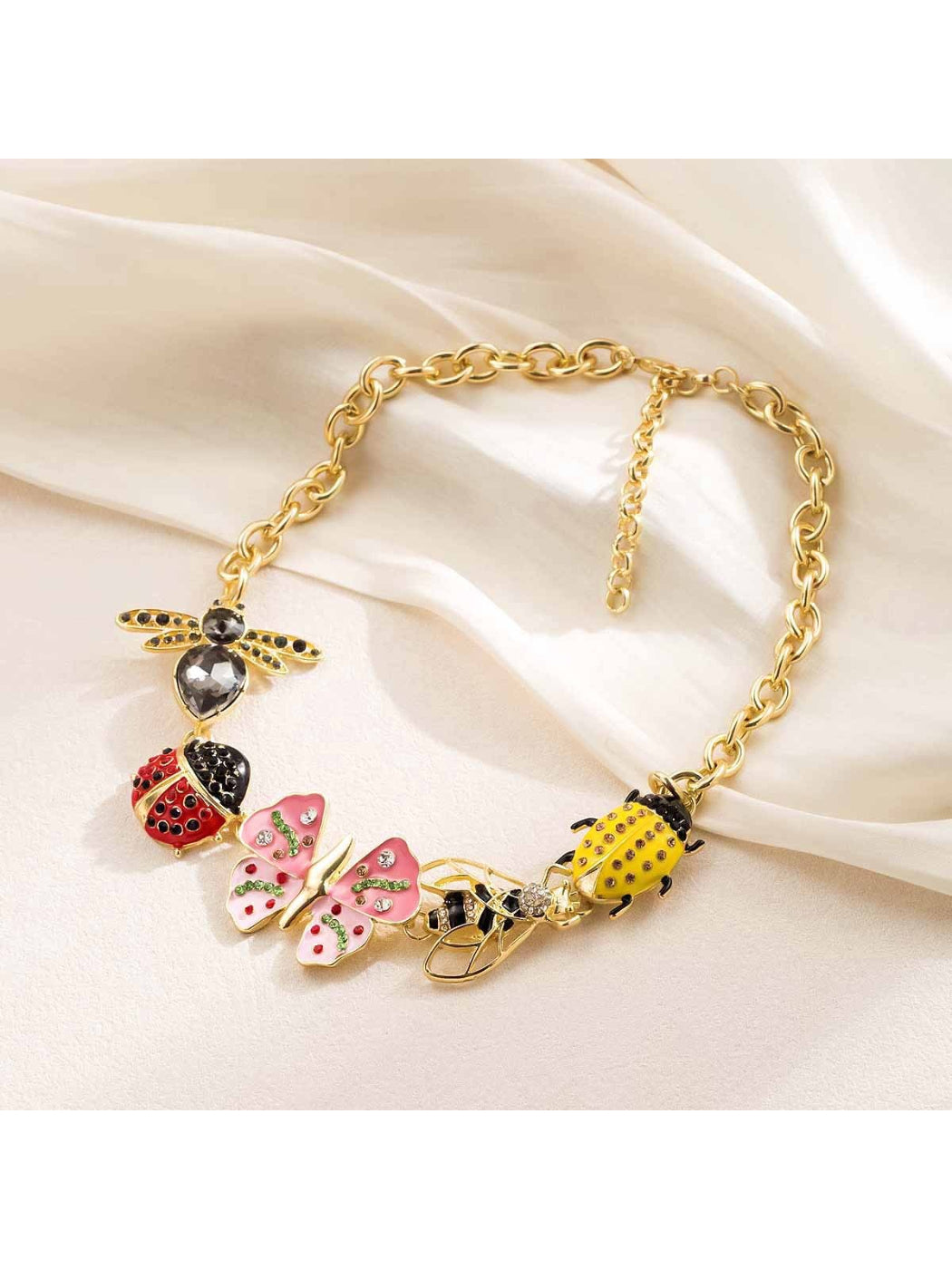 Side view of Neckit Butterfly & Bug Charm Necklace showing charm thickness and texture