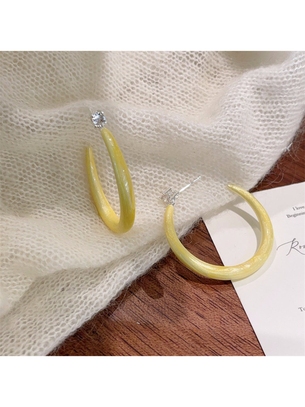 Glossy color hoop earrings in multiple colors on display