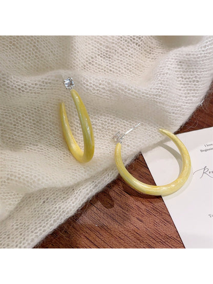 Glossy color hoop earrings in multiple colors on display