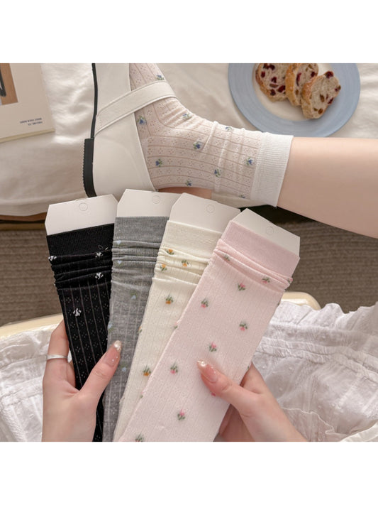 Pair of Rufia Ditsy Floral Ribbed Crew Socks in pastel colors displayed flat
