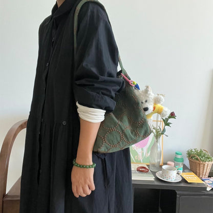 Close-up of olive green leather texture and stitching detail on Cosbai slouchy shoulder bag