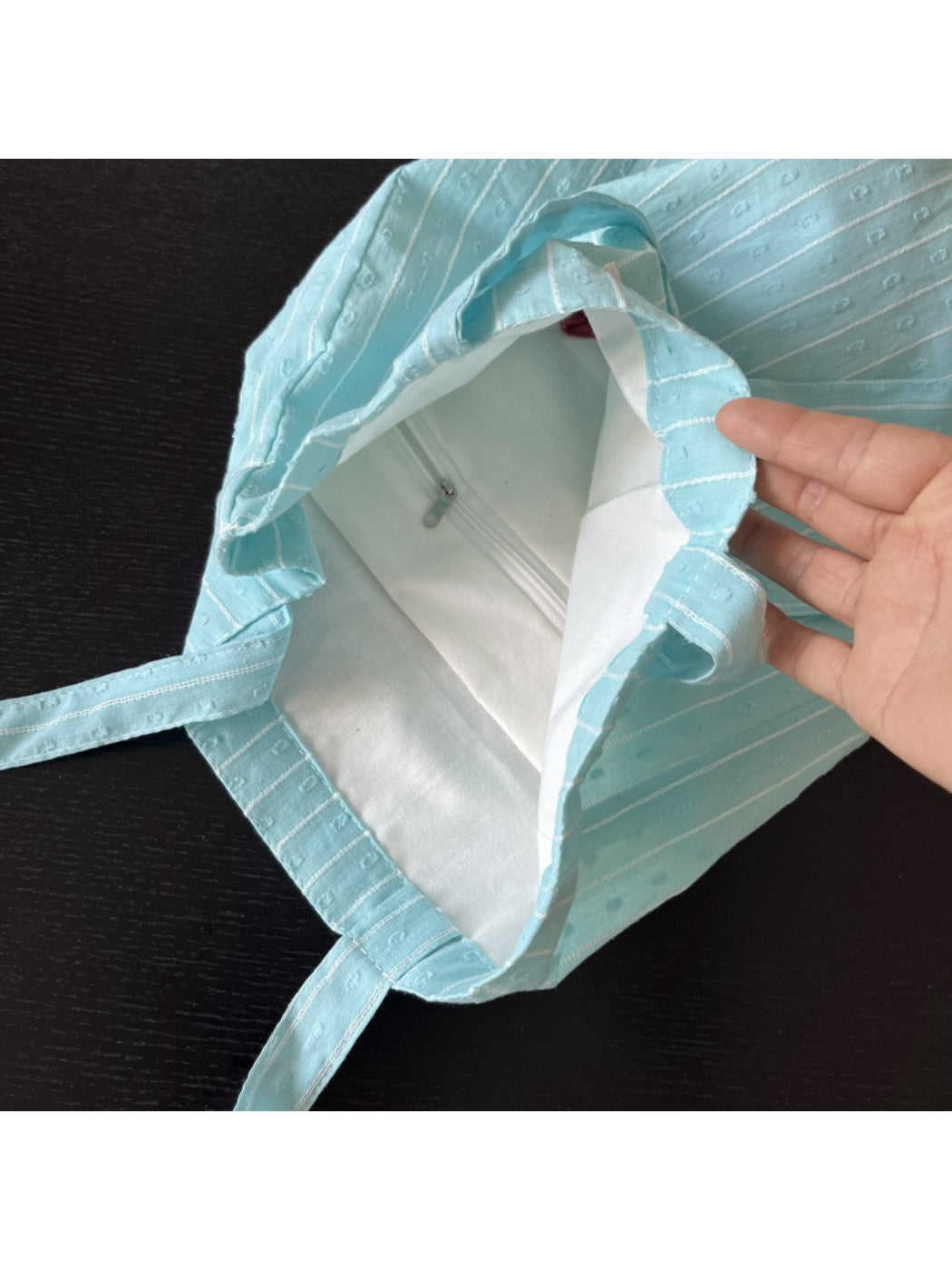 Side view of Cosbai sky blue textured tote bag highlighting shape and structure