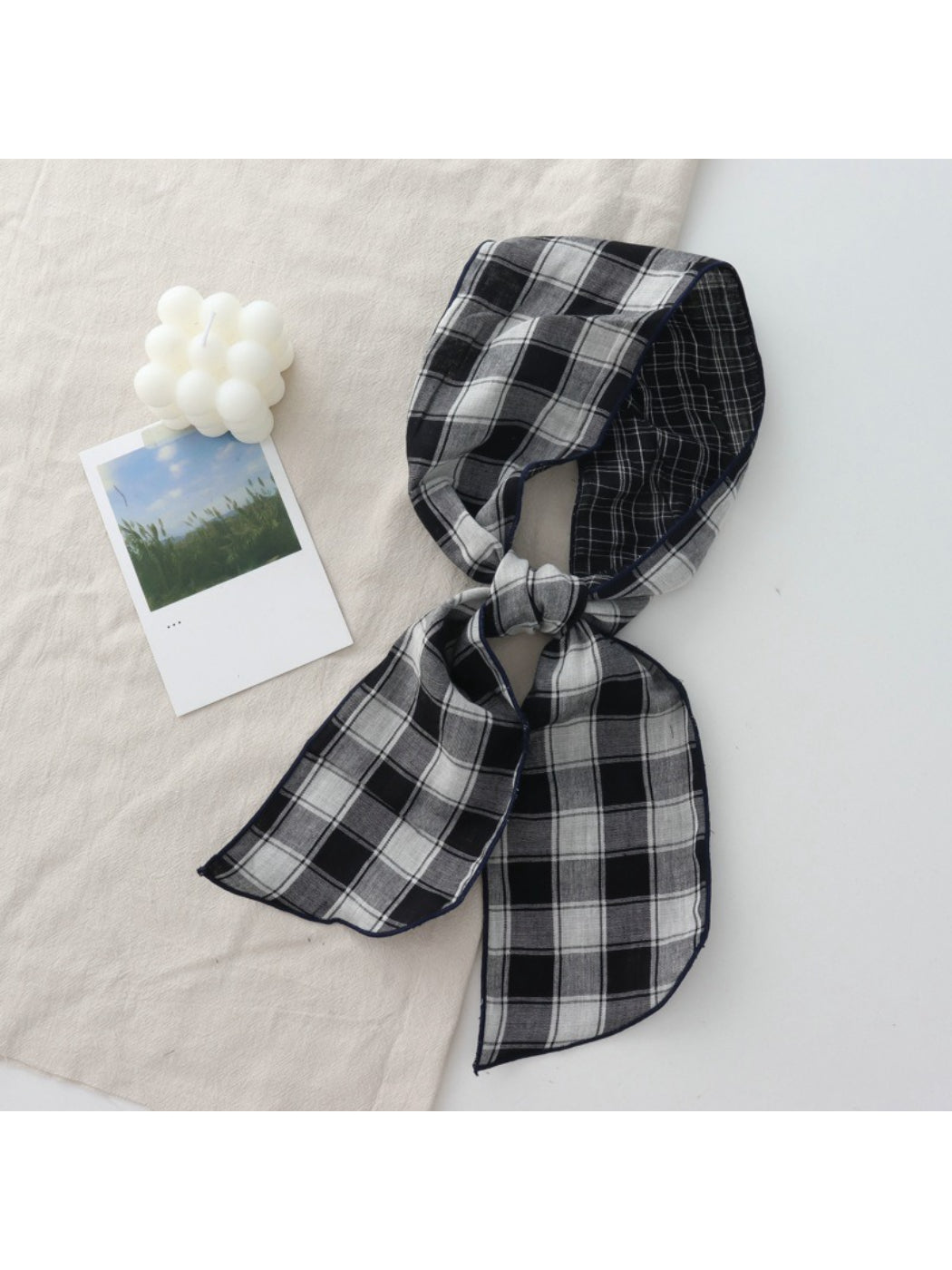 Scarvii Everyday Plaid Skinny Scarf draped over a wooden hanger