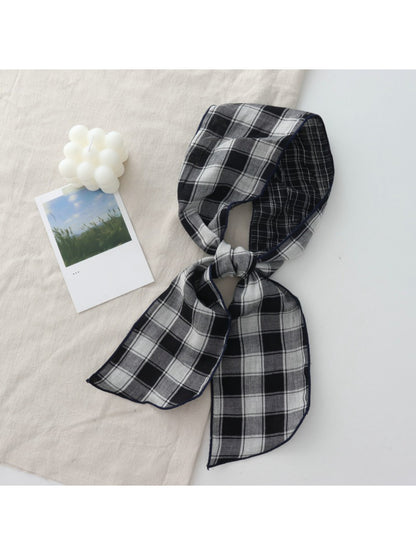 Scarvii Everyday Plaid Skinny Scarf draped over a wooden hanger