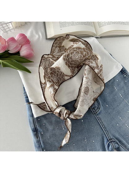 Scarvii elegant lace print scarf draped over a wooden hanger against white background