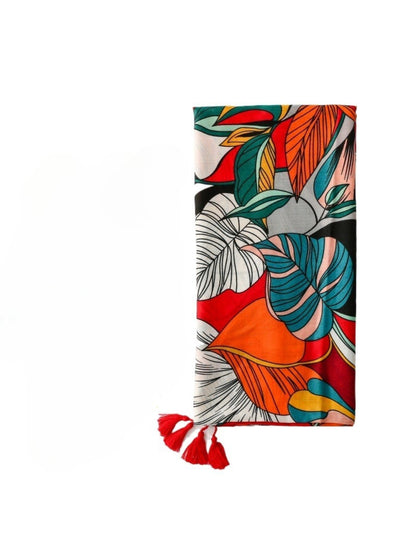 Close-up of vibrant tropical leaf pattern and tassel detail on Scarvii scarf