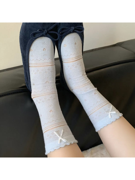 Pair of soft blue ribbon socks displayed flat on a white background