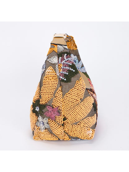 Side view of Cosbai shoulder bag showing black strap and embroidery details