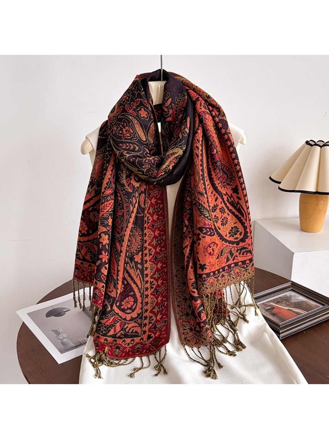 Scarf folded neatly with tassels visible on edges