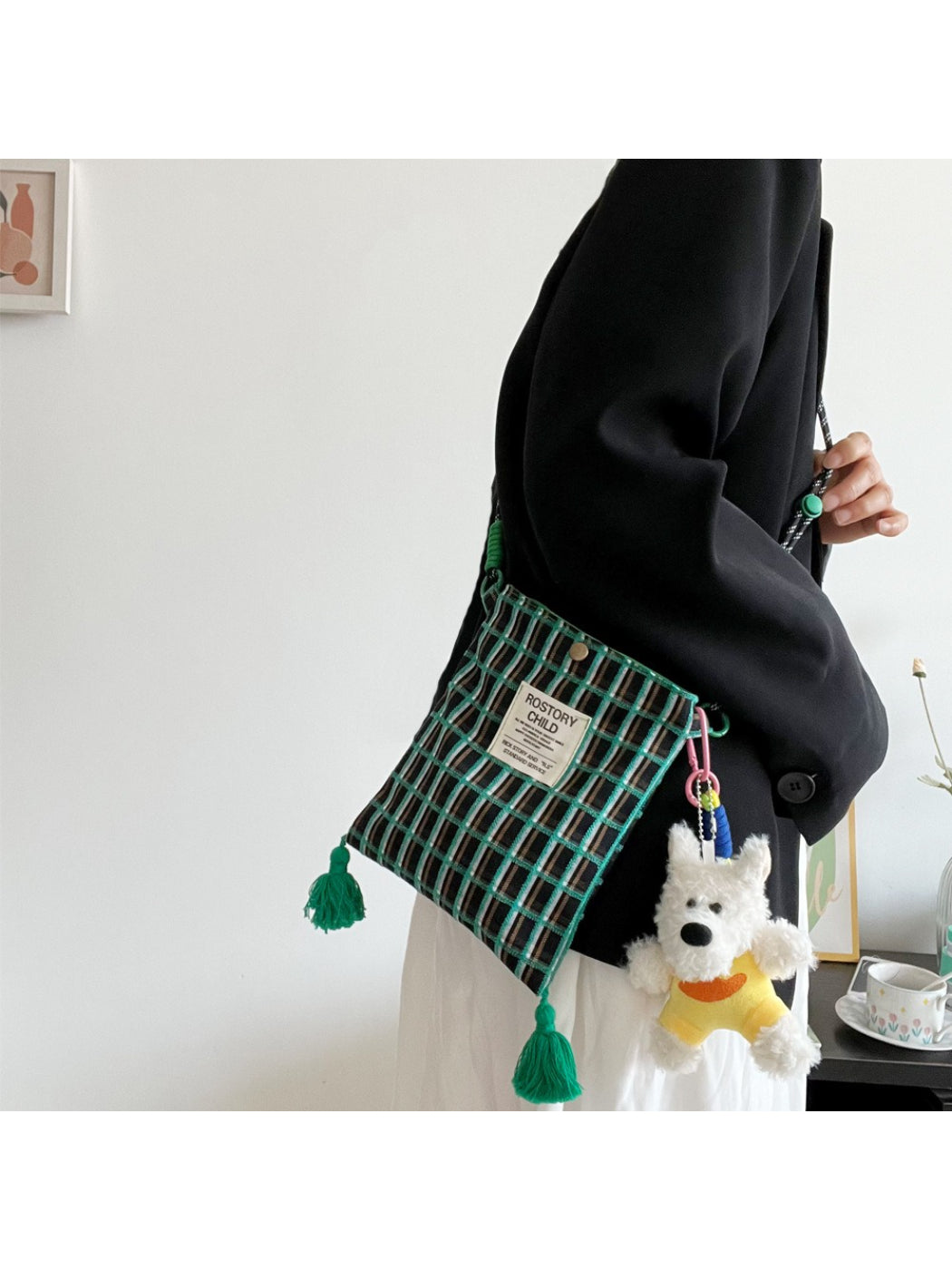 Close-up of plaid fabric and dog charm detail on Cosbai phone bag