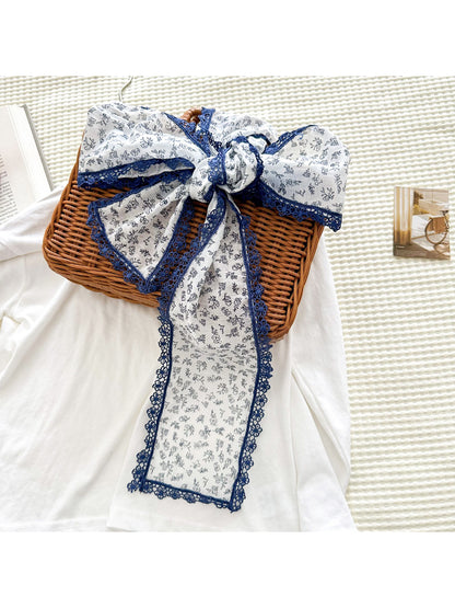 Scarvii floral skinny scarf styled around a neck with lace edges visible