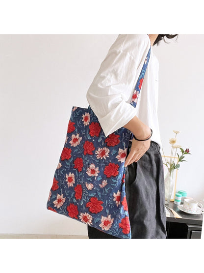 Side view of blue floral shoulder tote bag showing depth and stitching