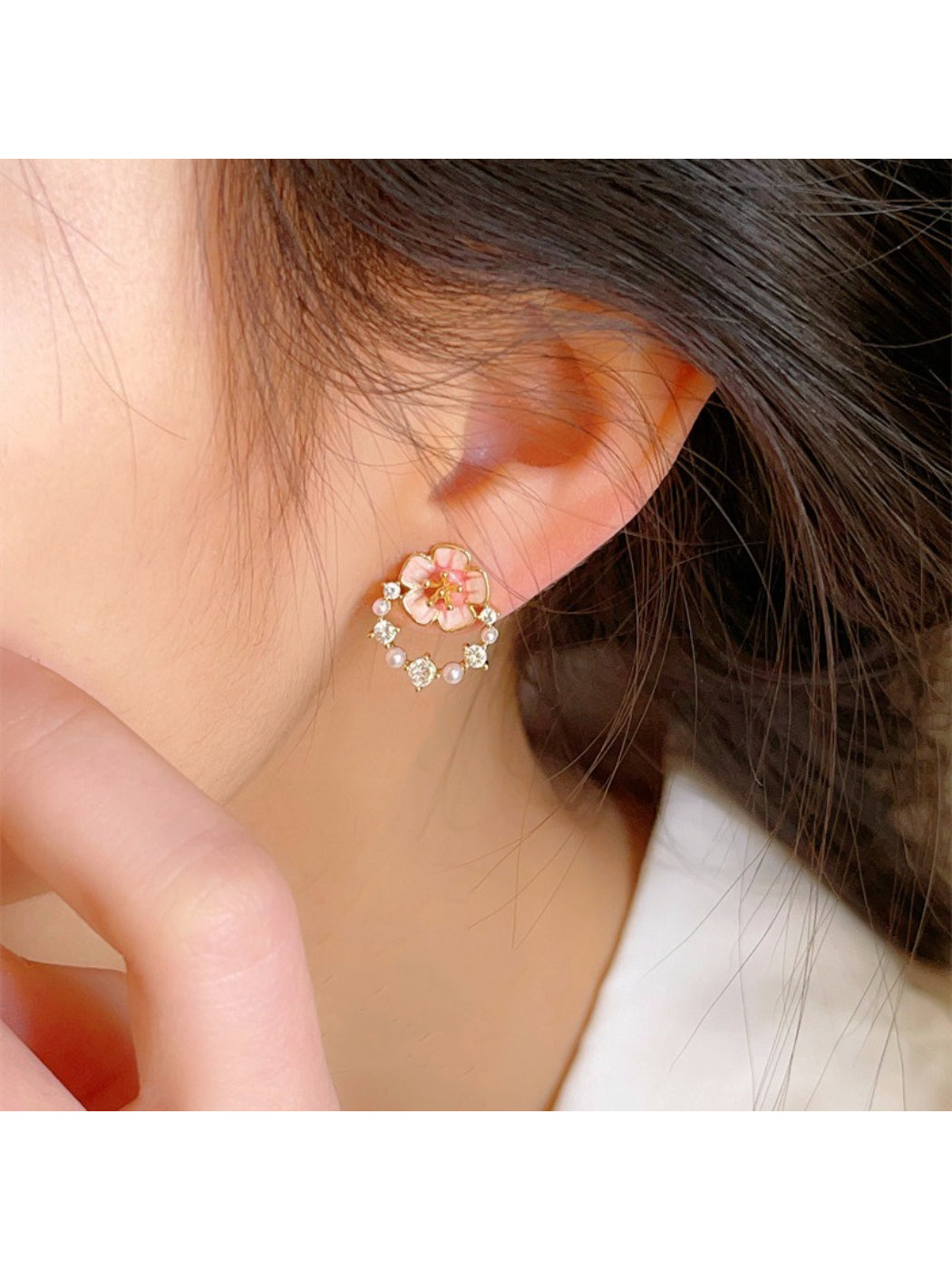 Pink flower accent earrings displayed on a white background