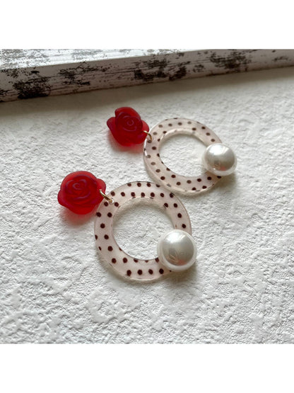 Close-up of Earwish Polka Dot Ring Drop Earrings showing black and white polka dot design