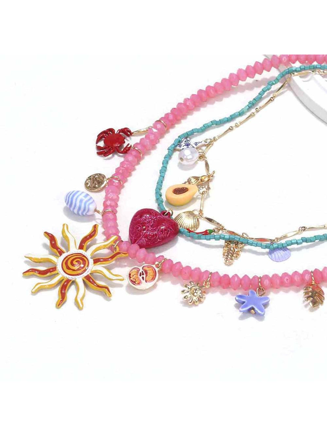 Side view of Neckit layered charm necklace highlighting sun and heart charms
