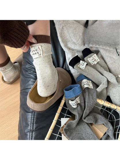 Pair of Rufia casual speckle knit crew socks in beige with multicolor speckles