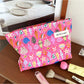Cosbai pink shell makeup pouch with a smooth, rounded shape on a white background