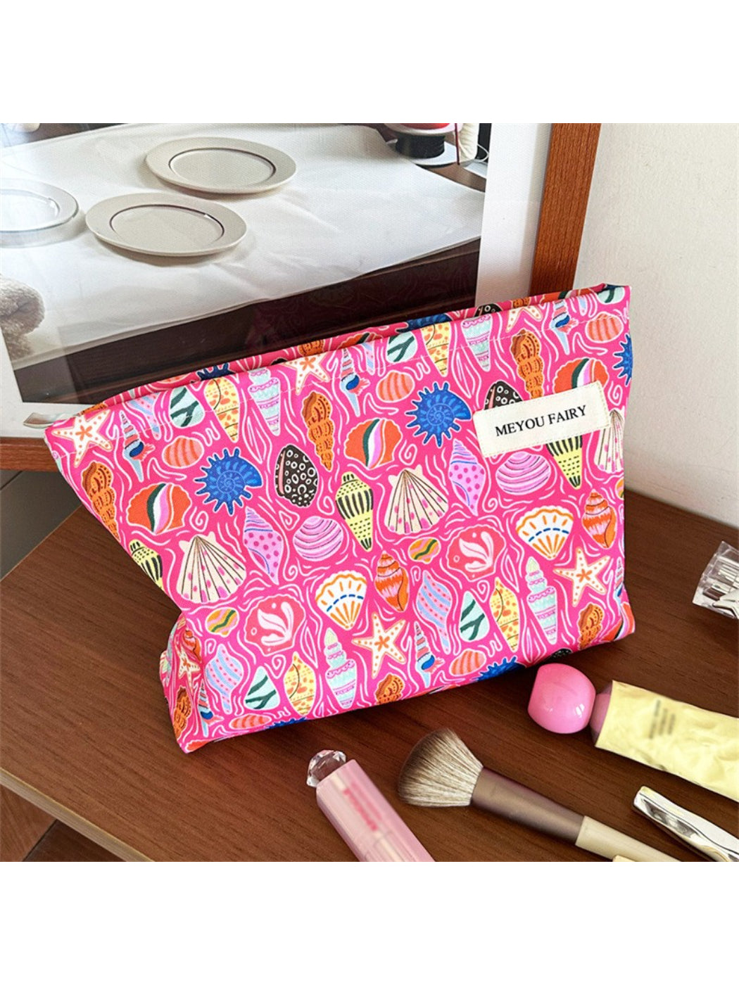 Cosbai pink shell makeup pouch with a smooth, rounded shape on a white background