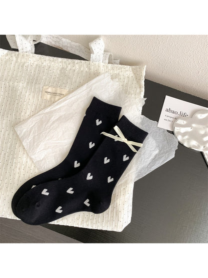 Model wearing Rufia soft crew socks with red heart pattern