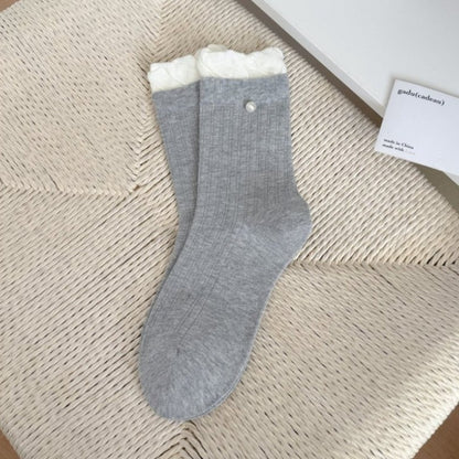 Pair of Rufia ribbed crew socks in white with delicate ruffle trim