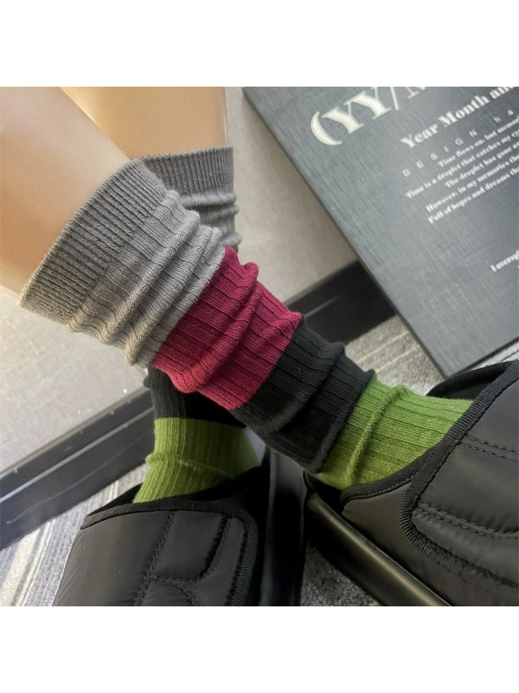 Pair of Rufia bold colorblock ribbed crew socks in blue, yellow, and white on a white background