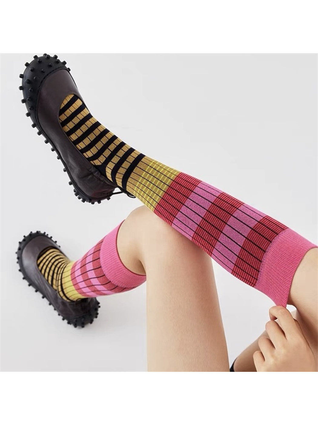 Side view of Rufia layered contrast stripe crew socks on a foot